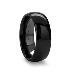 black ceramic wedding ring with polished finish inlayed to the center, on an isolated white background