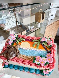 there is a large cake with flowers on the top and bottom layer that says happy birthday