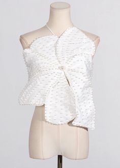 a mannequin with a white blouse on it