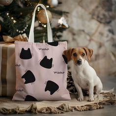 a small dog sitting next to a bag on the floor near a christmas tree with presents