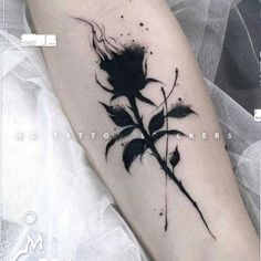 a black and white rose tattoo on the arm