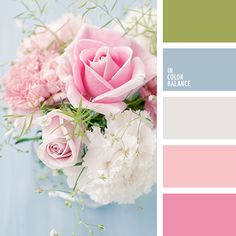 a vase filled with pink and white flowers on top of a blue table next to a color swatch