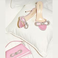 Elevate your ensemble with these stunning pink satin heels from Italy. Adorned with intricate crystal-cut detailing and a charming bow accent, they boast a sleek pointed toe and a wraparound ankle strap for a secure fit. With a towering stiletto heel and a luxurious padded leather footbed featuring a logo stamp, these heels offer both style and comfort. Perfect for adding a touch of glamour to any outfit, whether it's a special occasion or a night out on the town. Pink Bow Heels, Pink Satin Heels, Ribbon Heels, Diamond Heels, Pink Prom Dress, Pink Sparkly, Double Bow, Bow Heels, Satin Heels