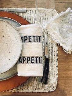 a place setting with utensils and napkins