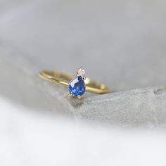 A 14K gold ring with a natural sapphire gemstone pear cut and a diamond brilliant cut in white gold or in yellow gold. A perfect engagement gold ring for women, stacking and delicate that adds glam to every outfit. Sapphire is the birthstone of September. 100% handcrafted with love! D E T A I L S ● Metal: 14K solid white gold, 14K gold, 14K rose gold ● Gemstones: Sapphire, Diamond ● Gemstones weight: Sapphire 0.4ct, Diamond 0.02ct ● Sapphire dimensions: 5.4 x 4.2 mm R I N G ∙ S I Z I N G For Gen Luxury Pear-shaped Sapphire Ring With Rose Cut Diamonds, Pear-shaped Sapphire Ring, Fine Jewelry Pear-shaped Sapphire Ring, Pear-shaped Yellow Gold Sapphire Ring, Fine Jewelry Yellow Gold Sapphire Ring Pear-shaped, Fine Jewelry Yellow Gold Pear-shaped Sapphire Ring, Yellow Gold Pear-shaped Sapphire Ring, Pear-shaped Sapphire Ring In 14k Gold, 14k Gold Pear-shaped Promise Diamond Ring