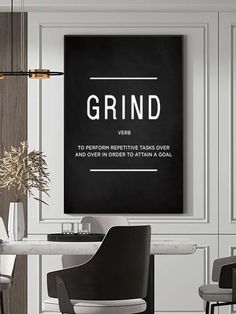 a black and white poster with the words grind on it in front of a dining room table