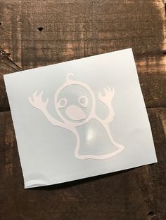 a white sticker with an image of a bird on it's face and arms