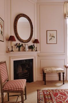 a living room filled with furniture and a fire place next to a mirror on the wall