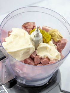 a food processor filled with meat and mayonnaise