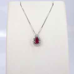 "White gold 14k necklace set with a pear shaped natural ruby 6×4 mm, 0.45 carat, surrounded by 16 halo round diamonds of 0.14 carat weight VS-G grade. Including a box chain 18\" Long. The ruby and diamonds are 100% natural of a very high quality, the diamonds are full of sparkle. The pear shape ruby weights 0.45 carat is full of rich color, surrounded by a halo of 16 diamonds of 0.14 carat VS-G Gold: 14k 1.90 gram (approx.) Chain: 16\"/18\"/20\" long Ruby: 0.45 carat, 6x4 mm, the ruby is natural Red Diamond Teardrop Necklace, Red Teardrop Diamond Necklace, Ruby Teardrop Pendant Necklace, Ruby Gemstone Teardrop Pendant Necklace, Formal Pear-shaped Ruby Necklace, Elegant Ruby Teardrop Pendant Necklace, Red Diamond Teardrop Pendant Necklace, Teardrop Fine Jewelry Necklace With Halo Setting, Fine Jewelry Teardrop Necklace With Halo Setting