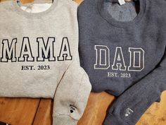 "Get one of these trending Mom Dad Est date crew neck sweatshirts with or without kids names on sleeves These are fast becoming the newest style for moms and dads this year Choose your shirt color and thread color.  Pictures shown for both.  If you prefer the ultra trendy \"tonal\" look, put that for your thread option and we have those colors already picked out to best match the shirt color 50/50 mid weight sweatshirt perfect for layering and fall nights Some items maybe substituted if they bec Mom And Dad Sweaters, Family Matching Long Sleeve Sweatshirt With Name Print, Casual Personalized Cotton Hoodie, Casual Cotton Hoodie Personalized, Personalized Long Sleeve Cotton Hoodie, Family Matching Long Sleeve Cotton Sweatshirt, Cotton Sweatshirt With Name Print For Streetwear, Cotton Sweatshirt With Name Print, Cotton Long Sleeve Sweatshirt With Name Print