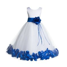 a white dress with blue flowers on the bottom and a bow at the waist is shown