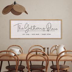 a wooden table with chairs and a sign above it that says the glittening place