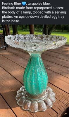 a blue glass vase sitting on top of a wooden table