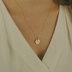 "This hammered disc necklace comes with a single 1/2\" 20g disc in your choice of Gold-Filled, Rose Gold Filled, or Sterling Silver. Perfect by itself, or layered with one or two other necklaces. Either blank or personalized with an initial. About the Hammered Disc Necklace: - 14K Gold-Filled (shown in photo), or Sterling Silver, or 14K Rose Gold-Filled 1/2\" round disc - 1.6mm Flat Cable Chain - your choice of length from 16\" - 24\" (Model in 1st photo is wearing about a 16\" chain, model in 2 Hammered Round Medallion Necklace As Gift, Minimalist Hammered Coin Necklace, Minimalist Hammered Round Coin Necklace, Elegant Hammered Round Medallion Necklace, Minimalist Round Hammered Coin Necklace, Elegant Hammered Medallion Necklace, Hammered Round Disc Minimalist Necklace, Hammered Medallion Coin Necklace Gift, Hammered Medallion Coin Necklace As Gift