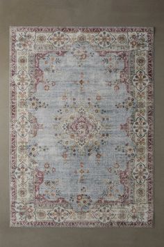 a blue rug with an ornate design on the top and bottom, in various colors