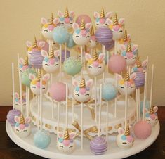 there is a cake that has many unicorn candies on top of it and some candy in the middle