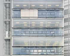 a tall building with lots of windows on it's sides and balconies