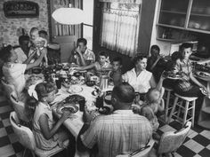 a group of people sitting around a table eating food