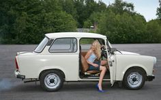 a woman sitting in the driver's seat of a white truck