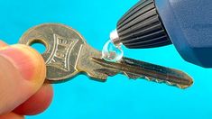 a hand holding a key to a blue object