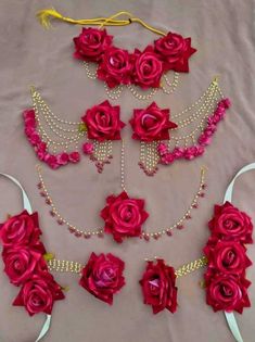 red roses and pearls are arranged on a table