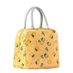 a yellow lunch bag with lemons and leaves on the front, sitting against a white background