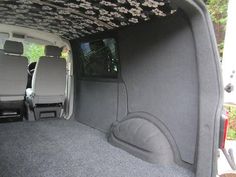 the back end of a van with its doors open and seats up in the passenger area