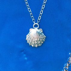 I love the beach. I love collecting shells. I always carry a plastic bag for trash when I collect shells so I can thank Mother Nature for the gifts she is giving me by helping to keep her clean. I always find more trash than treasure.  This is the perfect beach loving, wear-everyday kind of necklace.   Sterling silver shell and chain. Shell measures 15x15mm. Please choose chain length at checkout.  All Cabin No.7 jewlery arrives wrapped in colorful tissue paper and hand-stamped gift box- perfect Silver Shell Necklace For Gift, Silver Shell Gift, Sterling Silver Shell-shaped Gift, Sterling Silver Shell Necklace For Gift, Silver Shell For Beach With Ocean-inspired Style, Silver Coastal Jewelry Gift, Ocean-inspired Silver Shell Necklace, Coastal Style Silver Jewelry For Gifts, Coastal Style Silver Jewelry Gift