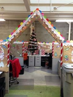 an office decorated for christmas with decorations on the walls and desks in front of it