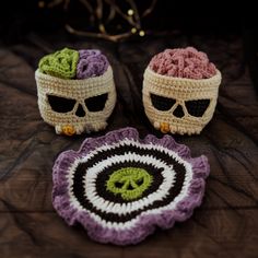 two crocheted skulls sitting next to each other