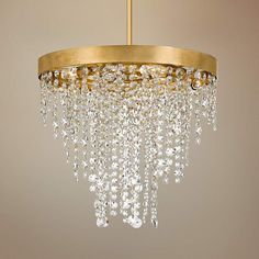 a gold chandelier with crystal drops hanging from it