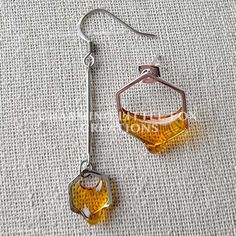 I make these earrings with resin and materials from Japan, resulting in a totally unique and exciting way to to share my love for the bees! I seriously considered becoming a beekeeper at one point... ha! Please keep in mind that each piece is handmade and may differ slightly. Though my jewelry is tough and reinforced, I do not recommend wearing in the shower or swimming A percentage of my Honey and Bee jewelry profits are donated to non-profit beekeeping organizations and other save-the-bees eff Dripping Honeycomb, Honey Jewelry, Asymmetrical Necklace, Bee Jewelry, Dangle Necklaces, Save The Bees, Hypoallergenic Earrings, Single Earring, Bee Keeping