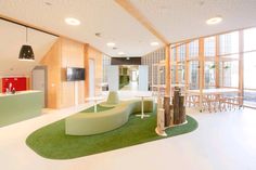 the interior of a modern office building with green carpeting and white walls, windows, and furniture