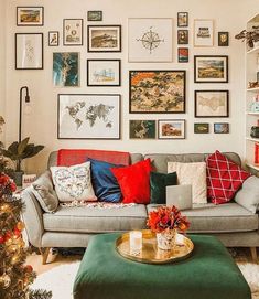 a living room decorated for christmas with pictures on the wall and a coffee table in front of it