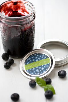 a jar of blueberries and jam on a table