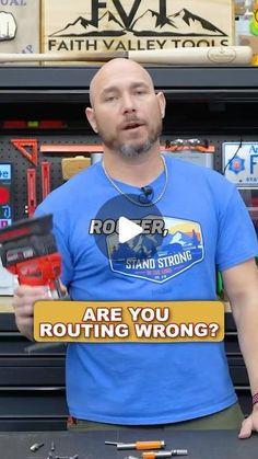 a man holding a sign that says are you rooting wrong? in front of some tools