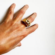 This was an exercise in patience. This ring is created out of a sheet of brass that I cut and split and wrapped back around. It's a sculptural and an unusual ring, but it's very comfortable to wear. About .75" wide at the bottom and varies around 1" at the top. Fabricated out of brass sheet and finished in 14k nickel free gold plate. Gold Brass Dome Ring, Hand Forged Brass Open Ring, Minimalist Hand Cast Gold Rings, Brass Dome Ring With Polished Finish And Open Design, Polished Brass Dome Ring With Open Design, Modern Brass Open Ring, Unique Yellow Gold Wide Band Open Ring, Adjustable Brass Wide Band Open Ring, Adjustable Gold Dome Ring