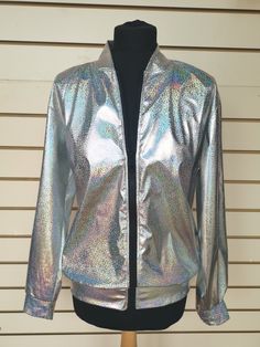 Holographic Silver Bomber style Jacket with sequin covered evil eye motif to the back of the jacket. Ideal for festivals and parties  Available in three sizes: SIZING S/M :    38-40" Chest   - Length  66cm    M/L :    42-44" Chest  -  Length 68cm        XL :    44-46" Chest - Length 71cm (length taken from back of neck to hem)  I have measured across the front of the jacket (laid flat with zip closed - underarm - underarm) If you are unsure what size to go for, you could compare these measurements with one of your jackets or shirts.  S/M :   56cm (22") M/L :  57cm (22.5")    XL :  58cm (23") Drop me a Etsy message if you have any questions about this jacket, or if you need any more measurements, and I will get back to you asap. I WILL DISPATCH YOUR ORDER WITHIN 3-5 DAYS, BUT IF YOU NEED IT Rave Long Sleeve Outerwear For Fall, Fall Rave Long Sleeve Outerwear, Fall Rave Outerwear With Long Sleeves, Metallic Disco Outerwear For Party, Iridescent Fitted Long Sleeve Outerwear, Fitted Disco Outerwear With Sequins, Fitted Disco Outerwear For Party Season, Fitted Iridescent Outerwear For Fall, Iridescent Outerwear For Fall Party