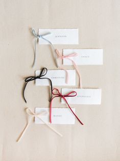 four different colored hair ties tied to each other on top of a white tablecloth