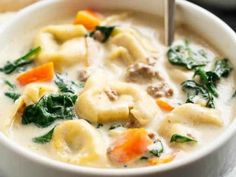 a close up of a bowl of soup with meat and veggies in it