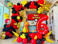 balloons are arranged in the shape of animals and numbers for a 6th birthday party at a children's playroom