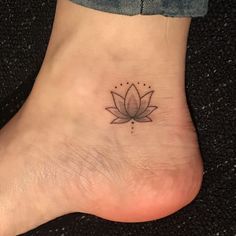 a lotus flower tattoo on the ankle