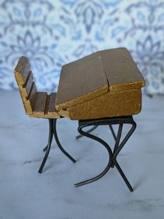 a miniature bench with a piece of bread on it