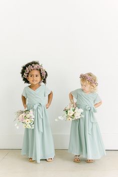 Our Kids Harper Chiffon dress is a nod to our adult faux wrap dress, letting your little one match your wedding party! Kids Harper features delicate bodice pleats, and translucent angelic sleeves, and is finished with an asymmetrical bow for that perfect amount of girly flare! Model Demi; Size: 3T / Length: Regular, Age: 3, Height: 3'0 Model Naveah; Size: 3T / Length: Regular, Age: 2, Height: 3'3 (measurements from 2021) FEATURES: Flowy A-line silhouette Surplice neckline Short sleeves Side zipp Bridesmaid Dresses And Groomsmen Suits, Bridesmaid Dresses And Groomsmen, Asian Bridal Wear, Modern Bridesmaid Dresses, Wedding Parties Colors, Indian Gowns Dresses, Modern Vintage Fashion, Bridesmaid Dress Colors, Convertible Dress