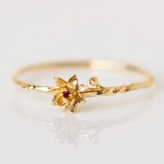 These unique solid gold birth month flower rings feature delicate and detailed flowers set with each month's birthstone. Discover this new take on personalized birth month jewelry.