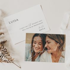 two women are smiling and looking at each other while holding their hands together in front of them