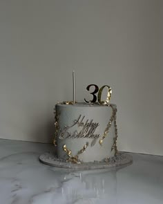 a birthday cake with the number 30 on it is sitting on a marble countertop