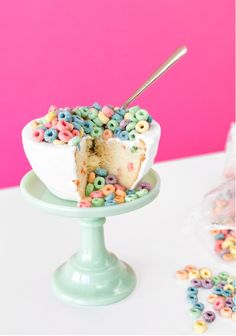 a cake with cereal toppings and a slice taken out of it on a plate