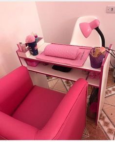 a pink chair and desk in a room